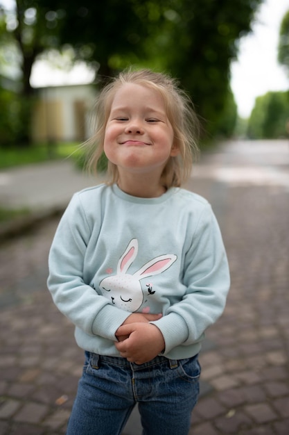 A little girl smiles funny at the camera Closeup