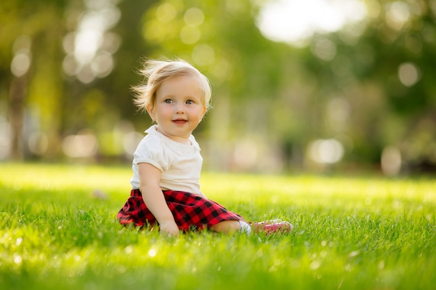 little girl smiling on the green grass