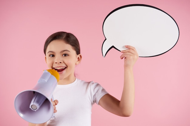 Little girl speaks into megaphone holding speech