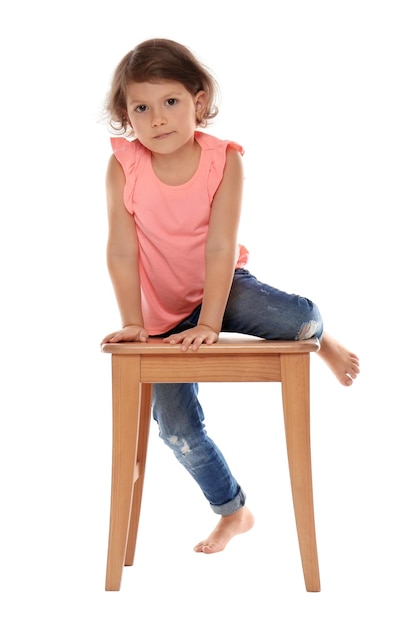 Little girl on stool against white background Danger at home