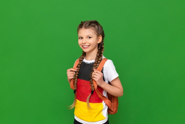 A little girl in a Tshirt with the image of the flag of Germany studying in Germany and learning German