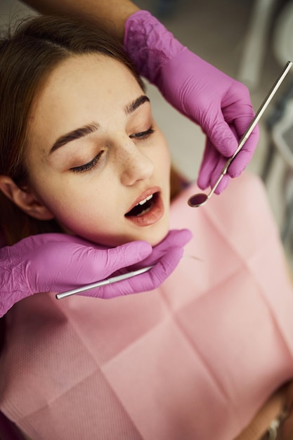 Little girl visiting dentist in clinic Conception of stomatology