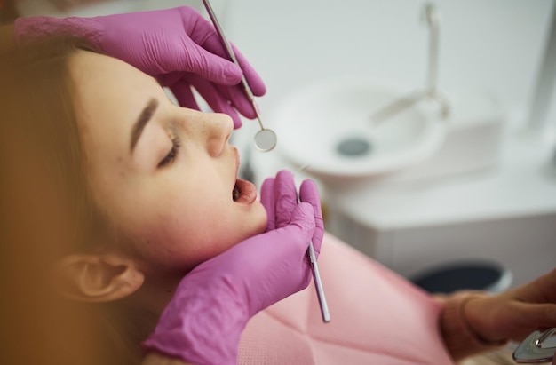 Little girl visiting dentist in clinic Conception of stomatology