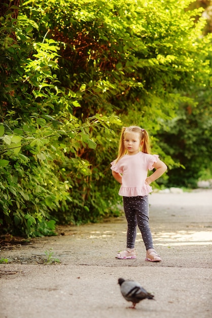 Little girl on the walk in summer time