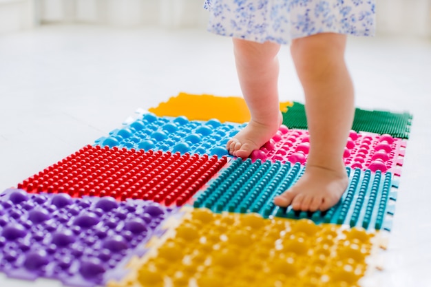 Little girl walking on massage Mat