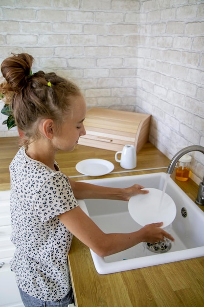 little girl washing dishes