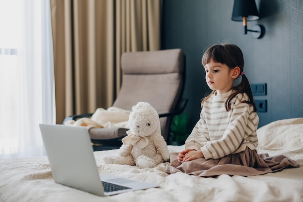 Little girl watching the laptop