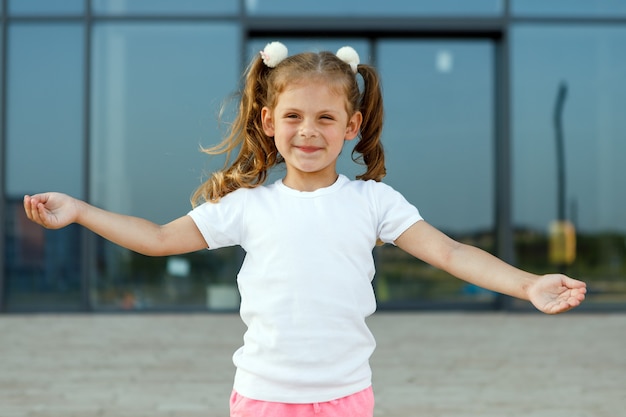 Little girl in white t-shirt. space for your logo or design. Mockup for print