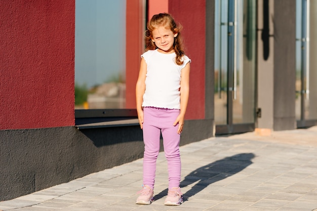 Little girl in white t-shirt. space for your logo or design. Mockup for print