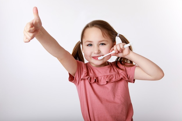 Little girl who enjoys the daily routine of brushing her teeth