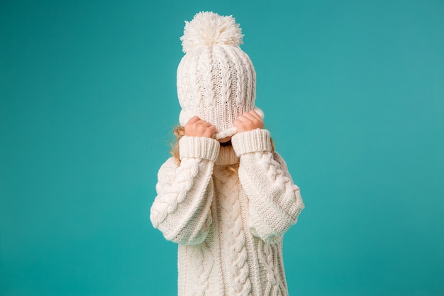 little girl in winter knitted hat and sweater