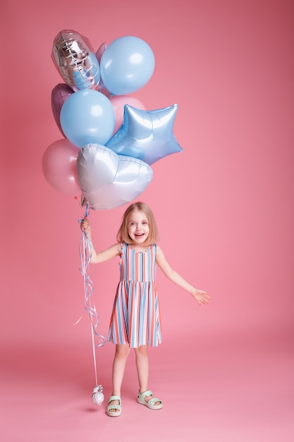 A little girl with balloons playing. Children's Day