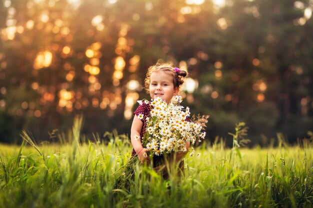 little girl with a big bouquet of daisies flowers