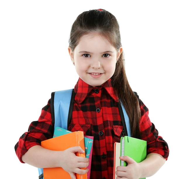 Little girl with blue back pack holding books isolated on white