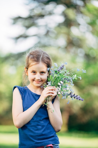 little girl with a bouquet of wildflowers.