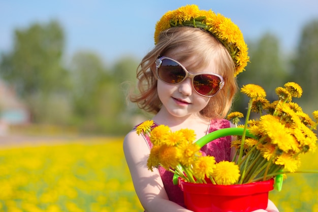 Little girl with dandelions