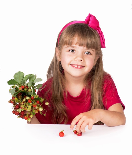 Little girl with flowers strawberries on a white background