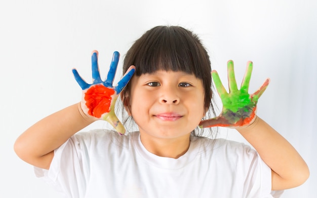 little girl with hands in paint on white 