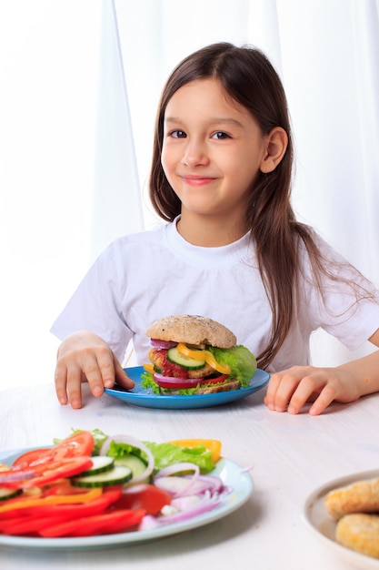 Little girl with a healthy vegan veggie burger