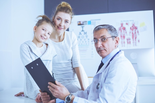 Little girl with her mother at a doctor on consultation