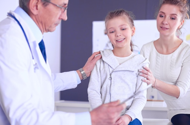 Little girl with her mother at a doctor on consultation