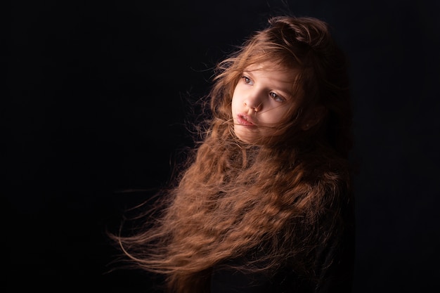 little Girl with long hair on a black