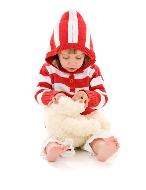 little girl with plush toy over white