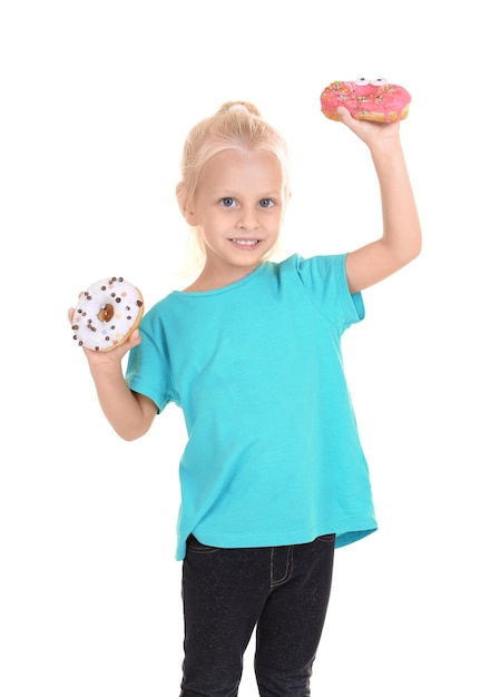 Little girl with sweet donuts on white background