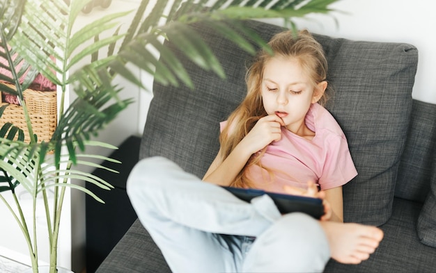 Little girl with tablet at home