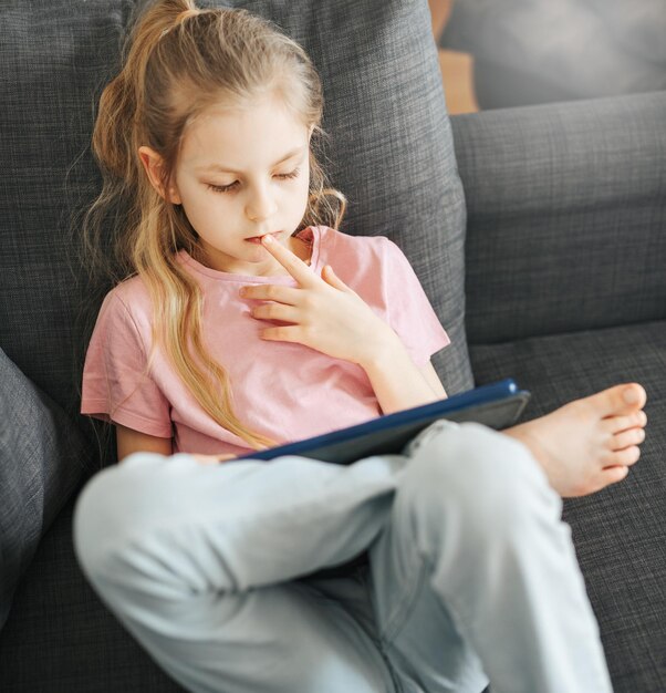 Little girl with tablet at home