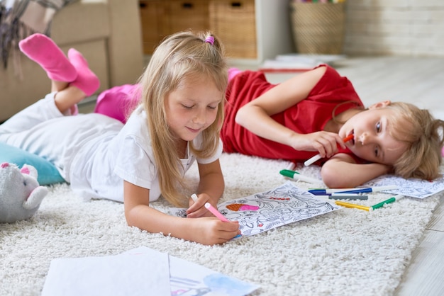 Little Girls Coloring on Floor