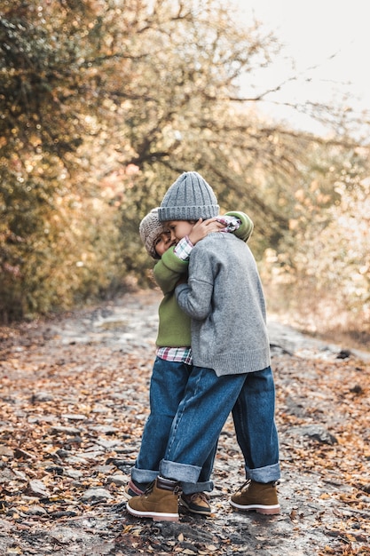 Little girls smile and enjoy life on an autumn day, friendship, sisters, relationships, family