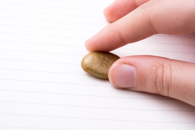 Little gold color pebble in hand