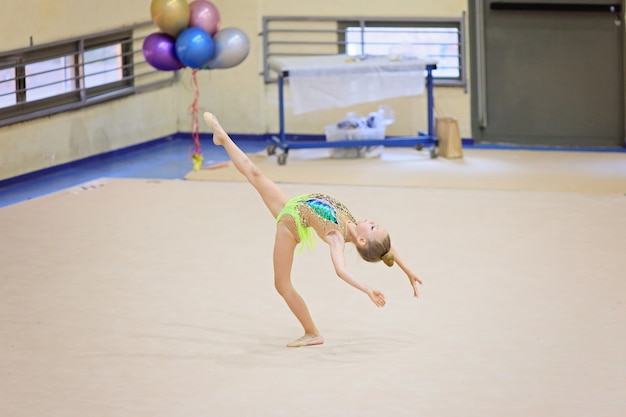 Little gymnast training on the carpet