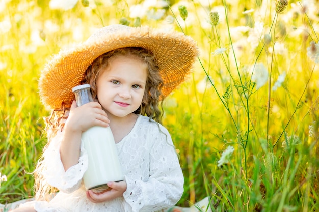 Little happy girl with a hat at a picnic