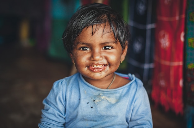 Little indian girl in dirty clothes