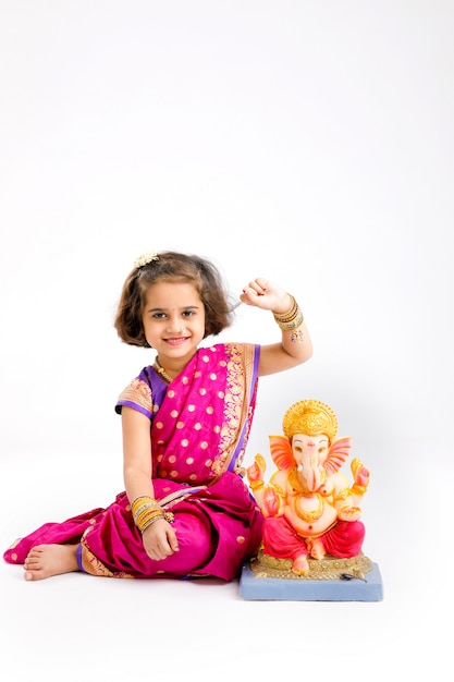 Little indian girl with lord ganesha, Indian ganesh festival