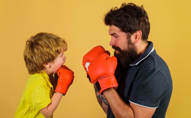 Little kid boxing with coach sport lifestyle training together family workout father training his