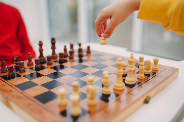 Little kids playing chess at kindergarten or elementary school