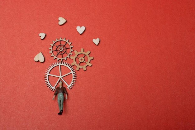 Photo little man figurine and gear wheel in view