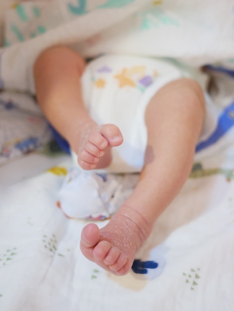 Little newborn baby feet close up