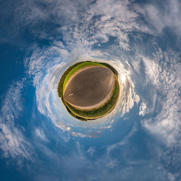 Little planet transformation of spherical panorama 360 degrees Spherical abstract aerial view in field in nice evening with awesome beautiful clouds Curvature of space