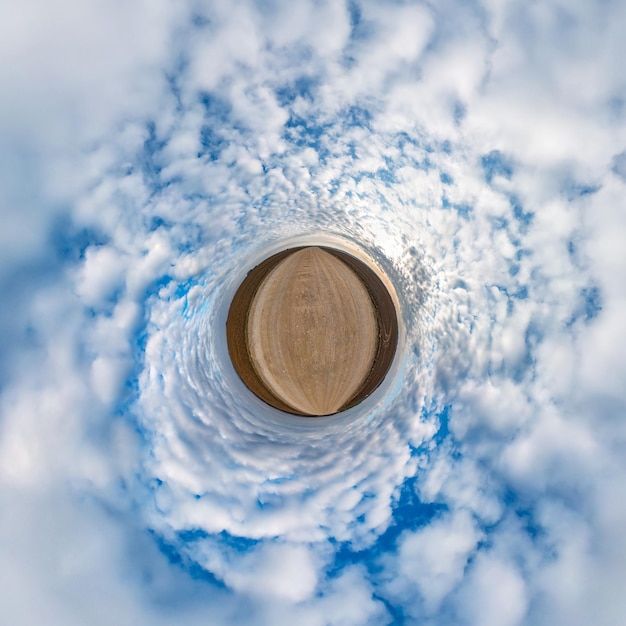 Little planet transformation of spherical panorama 360 degrees Spherical abstract aerial view in field with awesome beautiful clouds Curvature of space