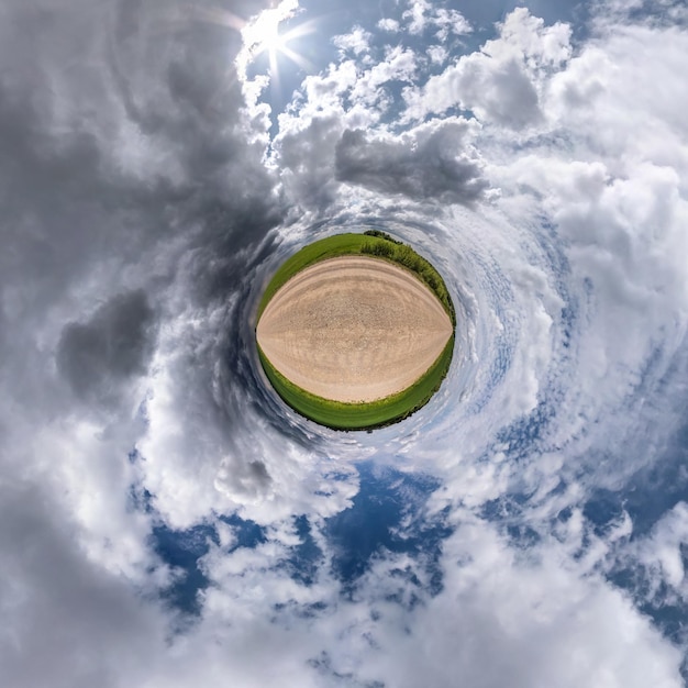 Little planet transformation of spherical panorama 360 degrees Spherical abstract aerial view in field with awesome beautiful clouds Curvature of space