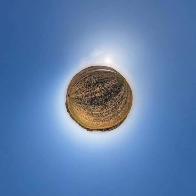 Little planet transformation of spherical panorama 360 degrees Spherical abstract aerial view in field with awesome beautiful clouds Curvature of space