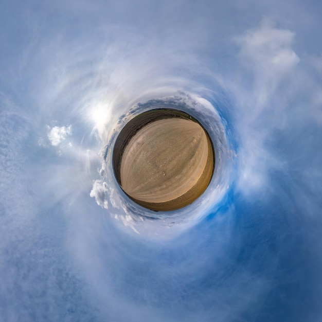 Little planet transformation of spherical panorama 360 degrees Spherical abstract aerial view in field with awesome beautiful clouds Curvature of space