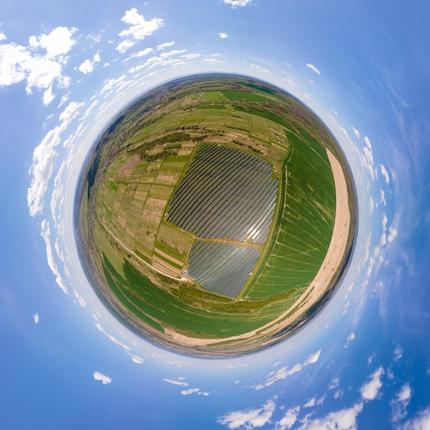 Little planet with big sustainable electric power plant with many rows of solar photovoltaic panels for producing clean ecological electrical energy. Renewable electricity with zero emission concept.