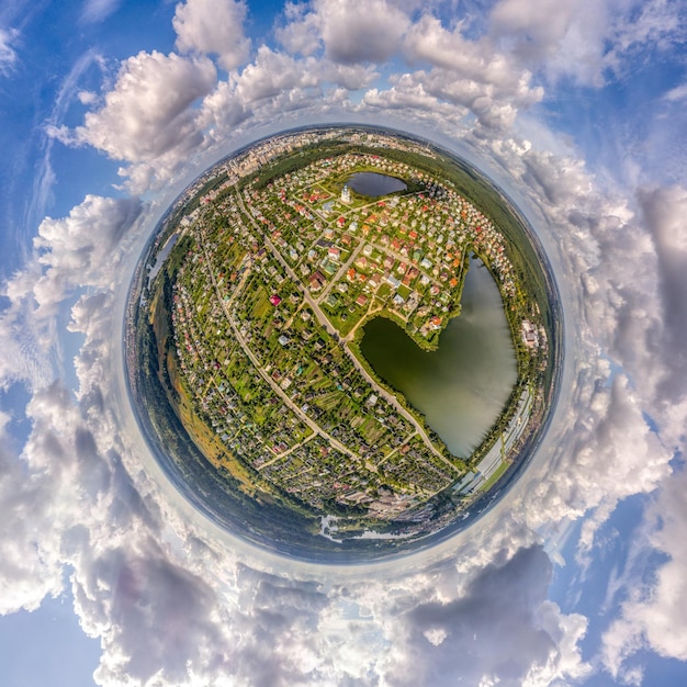 little planet with a holiday village and a lake from a bird's eye view