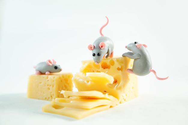 Little plasticine mice and a piece of cheese with holes