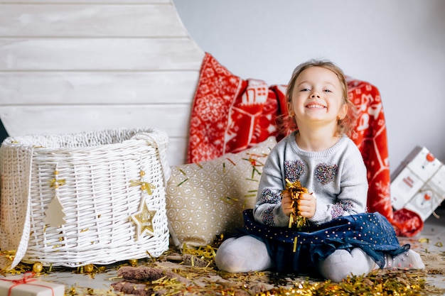 A little pretty girl with basket decorated with new year